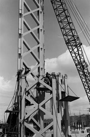 Crane and workers placing section of Space Needle - circa June 1961