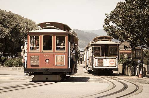 Two cable cars driving on tracks